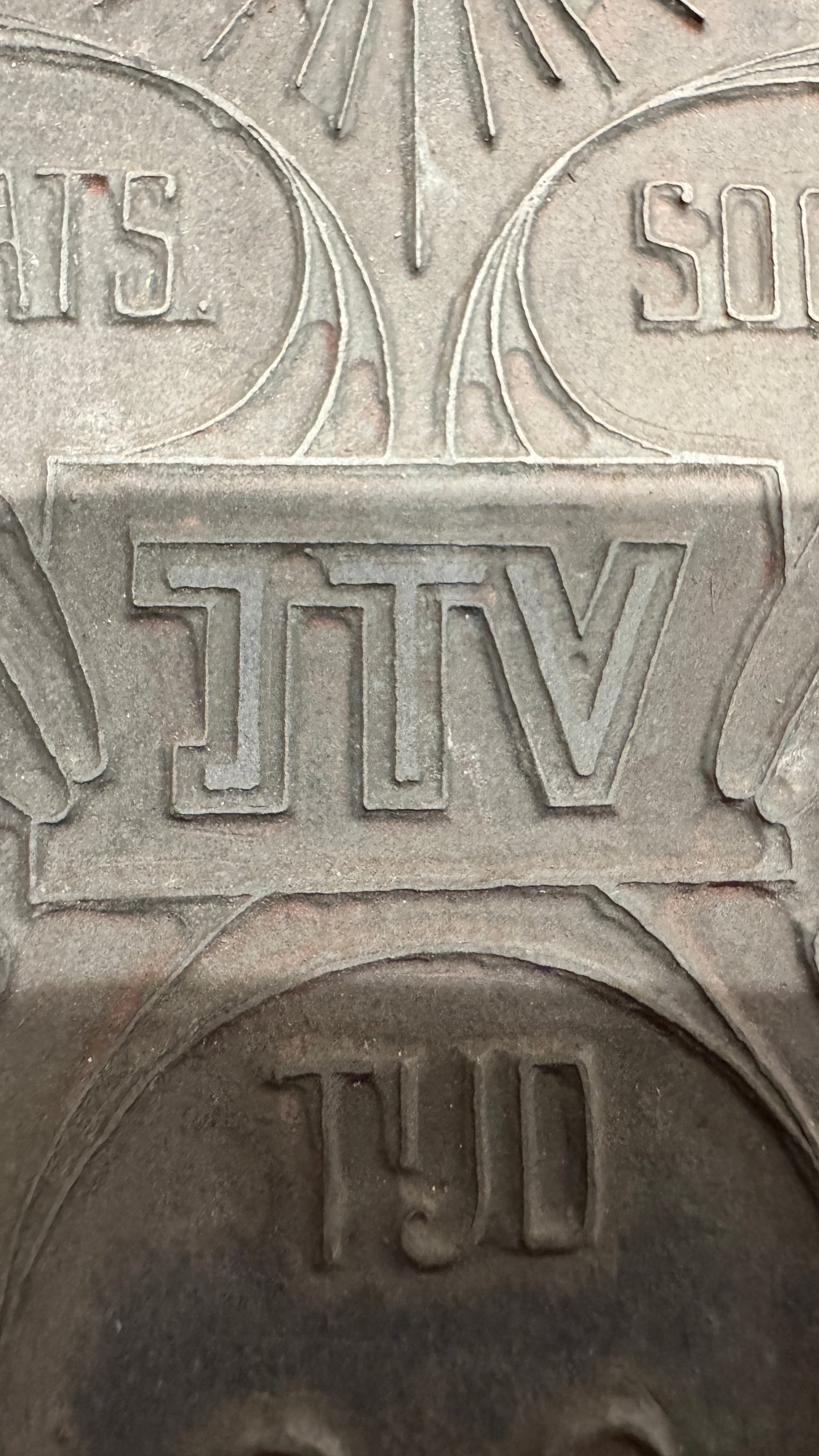Close-up of JTV lettering on WWII Dutch propaganda printing plate, relief letterpress design