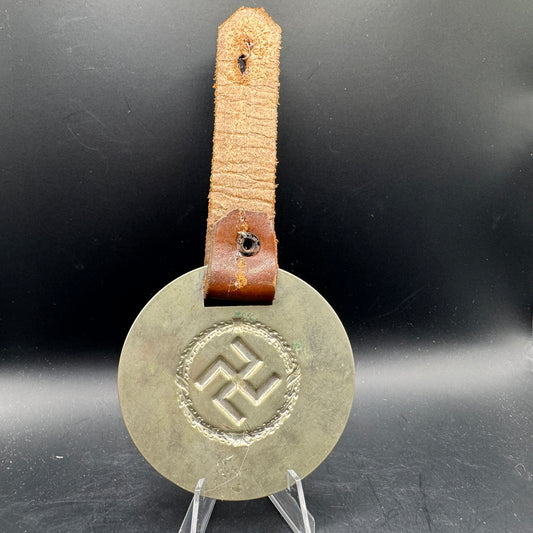WW2 original artifact – WWII-era German metal swastika mounted on leather – interior detail
