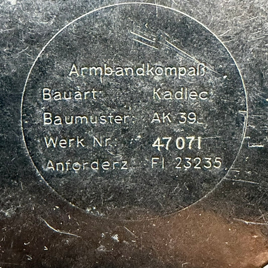 Reverse markings on WWII German Armbandkompass AK39 showing Kadlec manufacture, serial number and Fl 23235 designation.