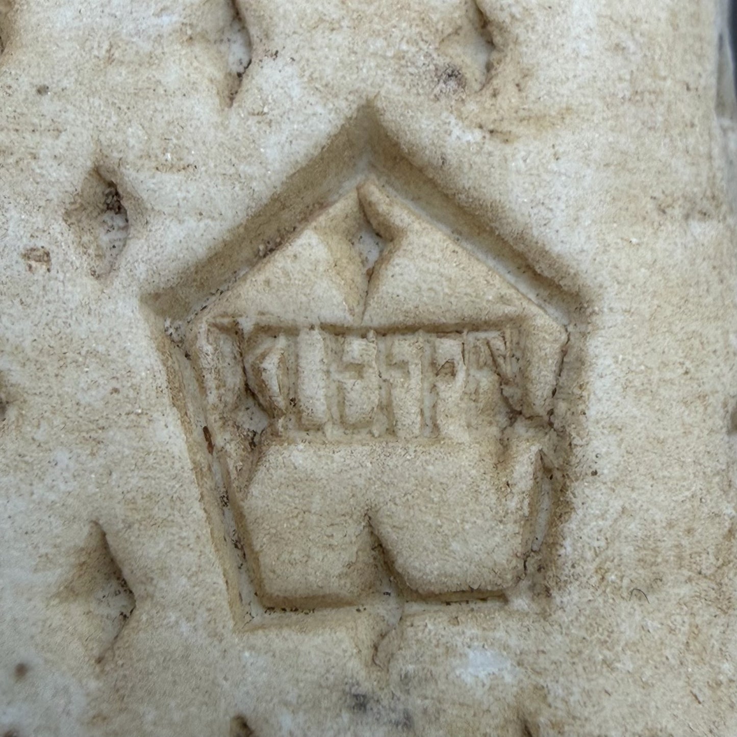 Factory or maker emblem cast into concrete marker