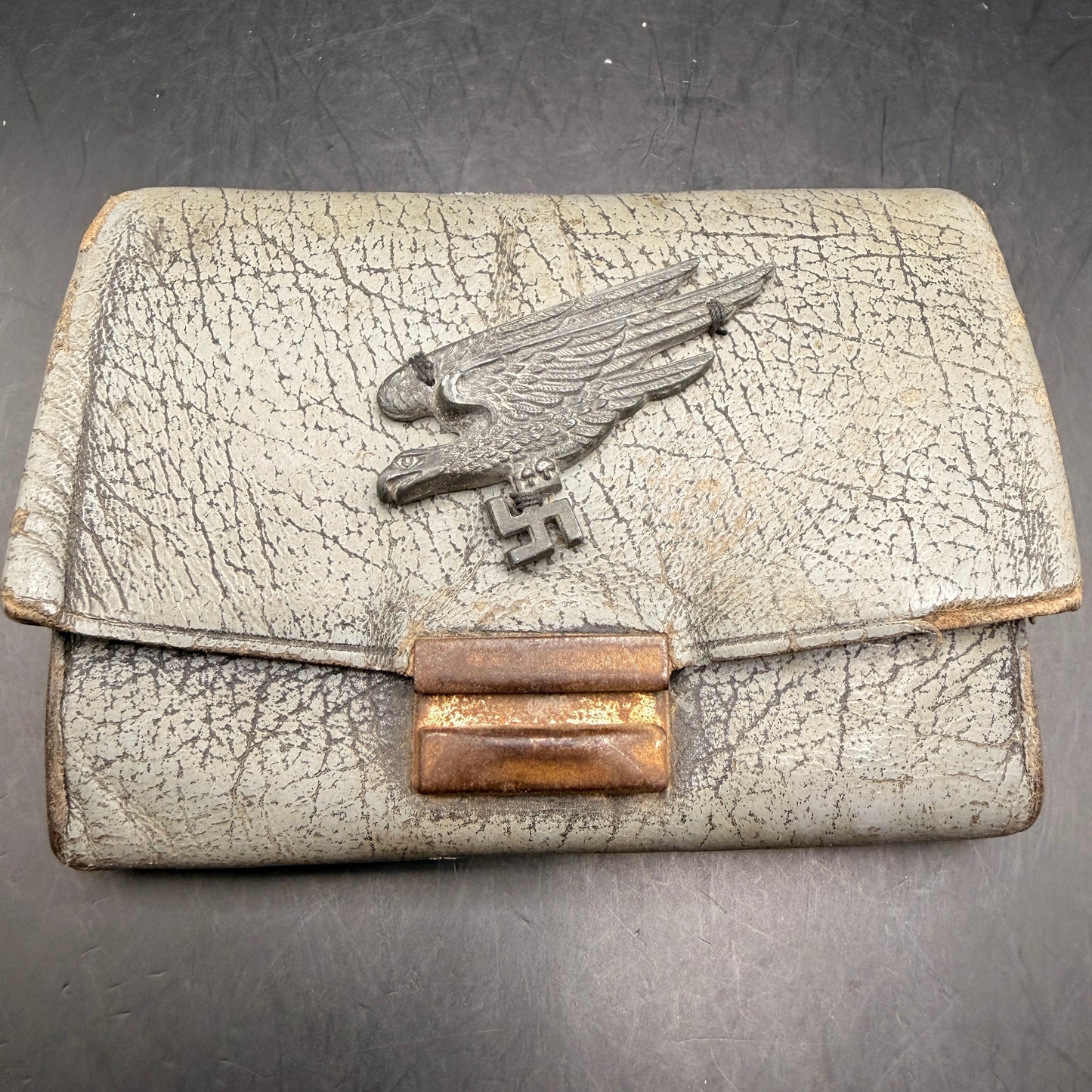 WW2 original artifact – WWII-era leather wallet, featuring a metal Fallschirmjäger-style eagle badge – AxisArtifacts