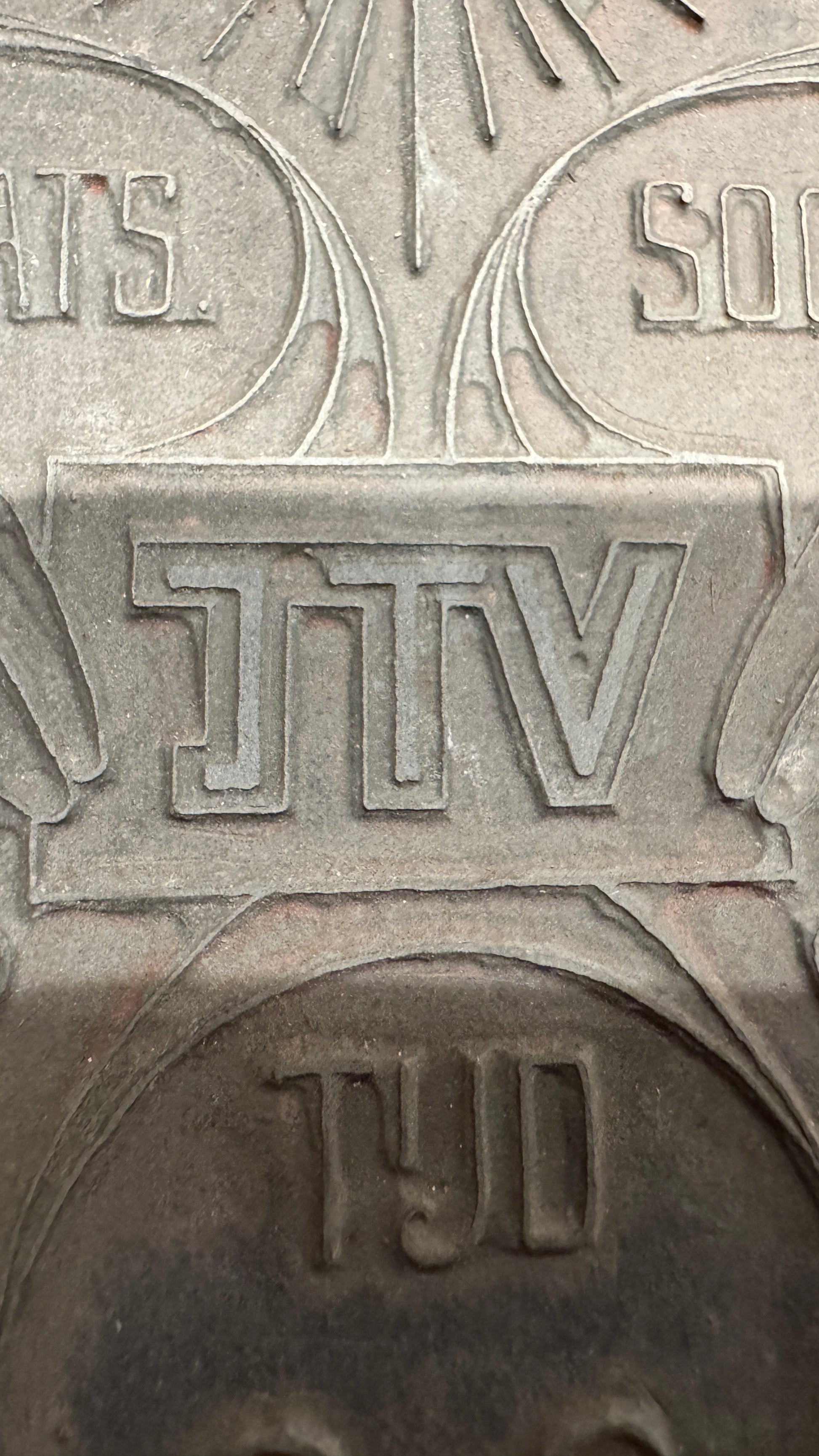Close-up of JTV lettering on WWII Dutch propaganda printing plate, relief letterpress design