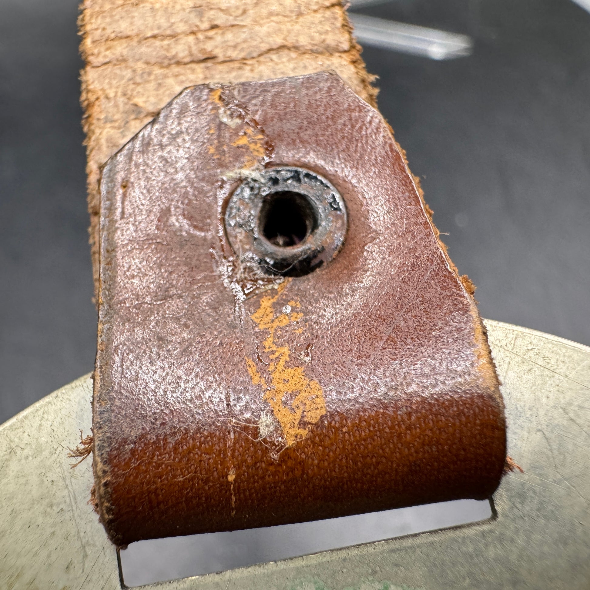 WW2 original artifact – WWII-era German metal swastika mounted on leather – interior page