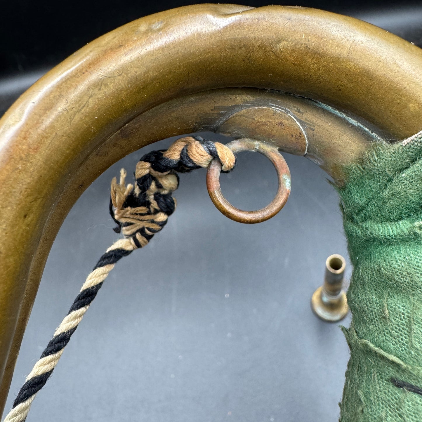 Curved tubing detail with original cord on German SA parade bugle
