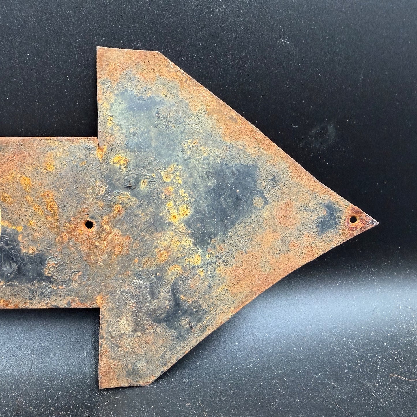 Left arrow detail of WW2 SS Wiking direction sign with original steel construction and rust patina