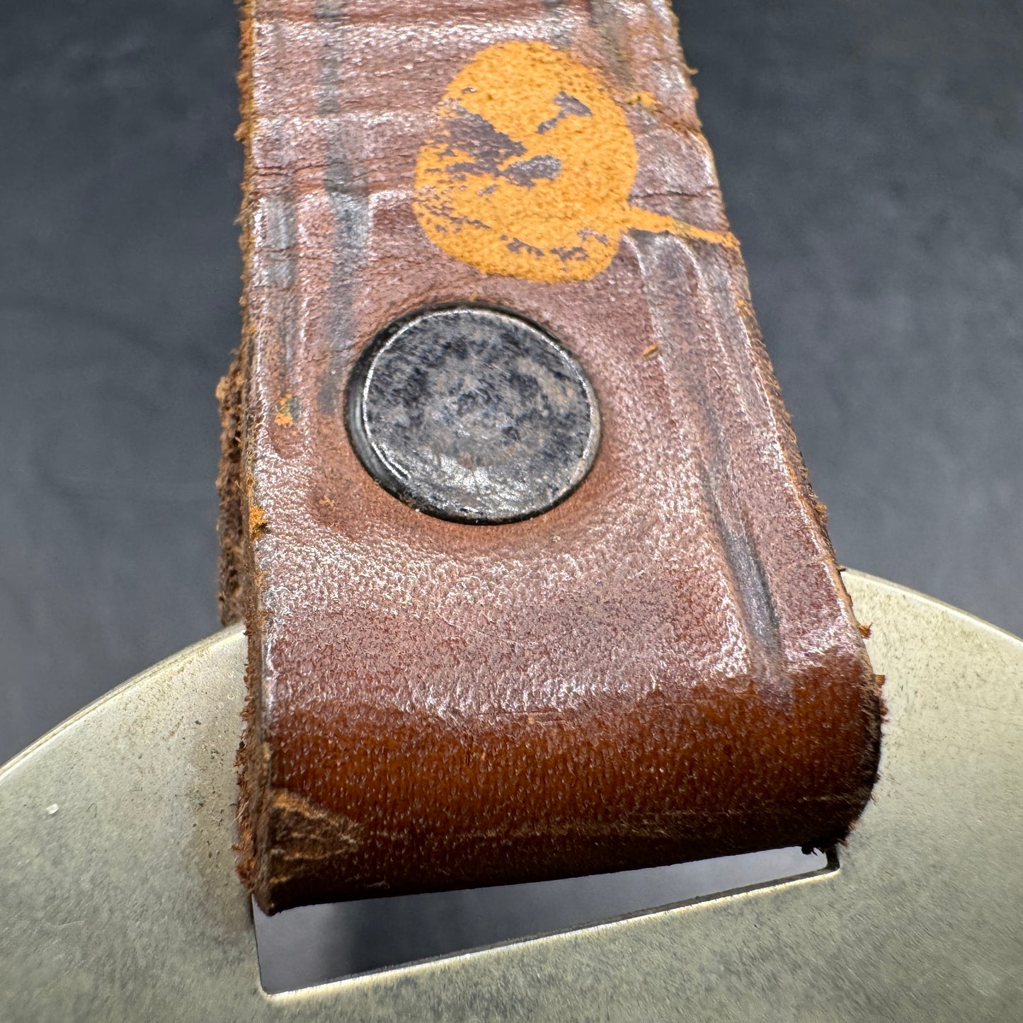 WW2 original artifact – WWII-era German metal swastika mounted on leather – interior page