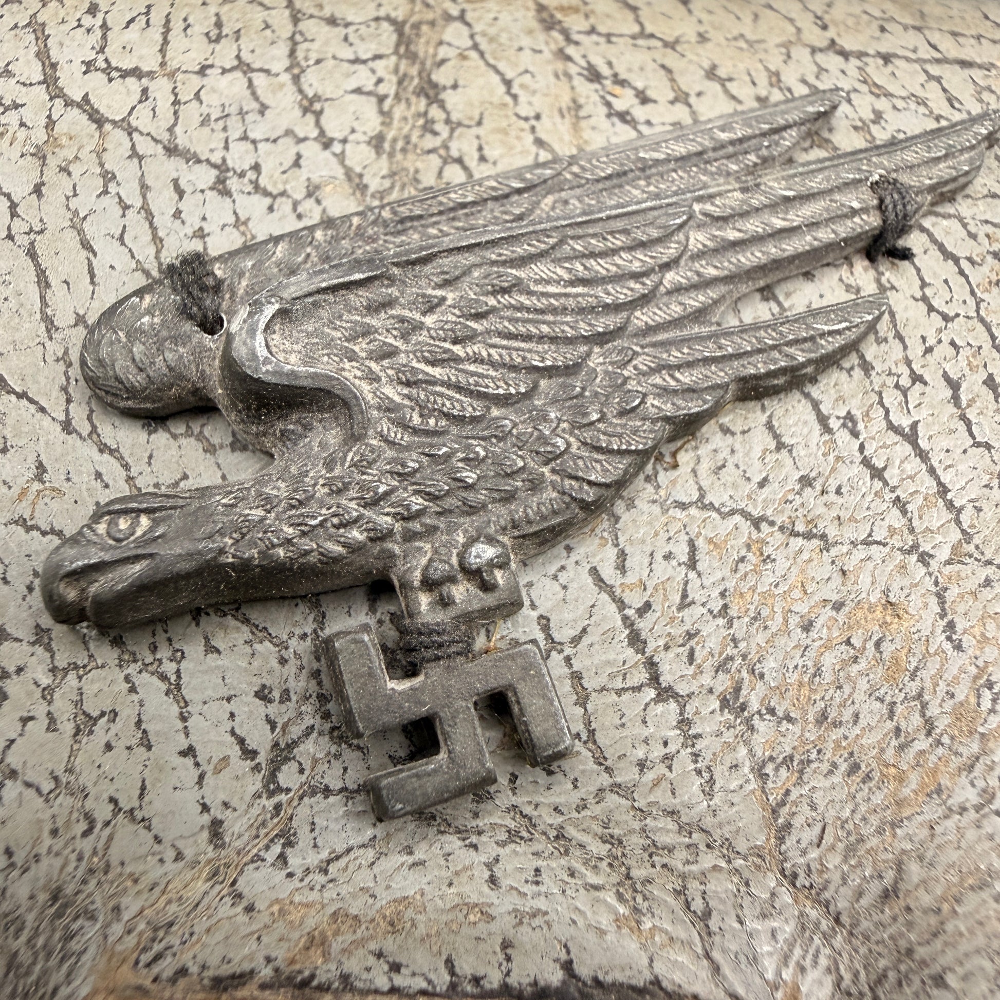 WW2 original artifact – WWII-era leather wallet, featuring a metal Fallschirmjäger-style eagle badge – interior detail