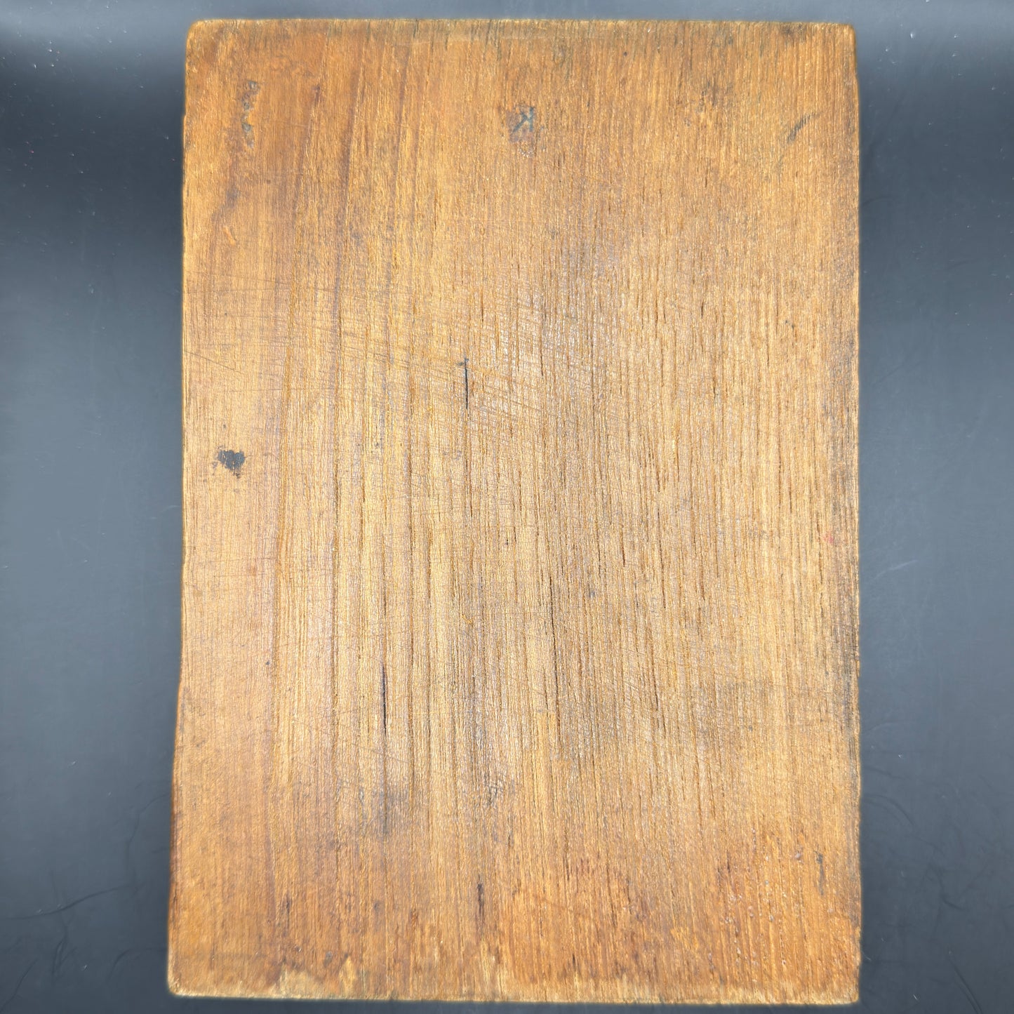Rear view of WWII era printing plate showing original wooden mounting block with age patina