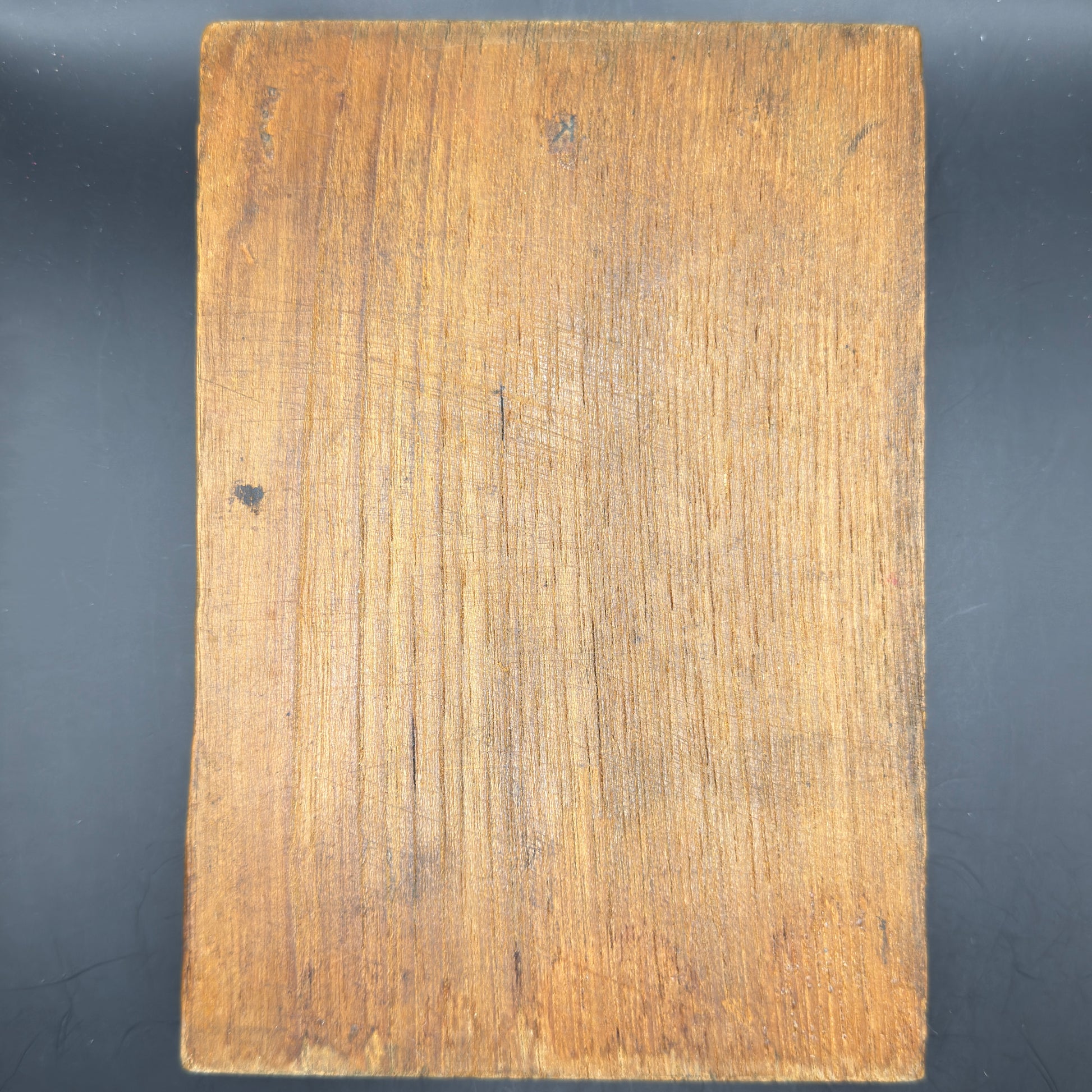 Rear view of WWII era printing plate showing original wooden mounting block with age patina