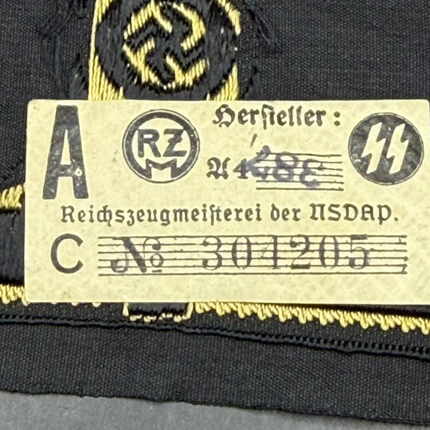 Close-up of RZM Reichszeugmeisterei tag with SS runes