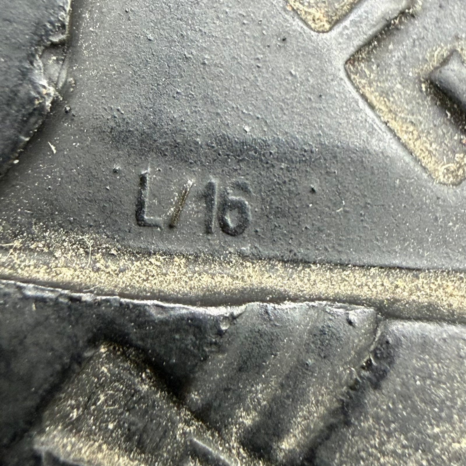 Macro detail of L/16 maker mark lower left in helmet