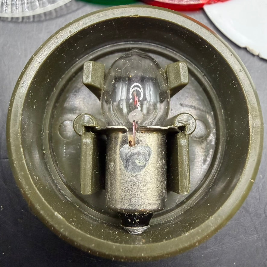 Interior view showing spare bulb compartment in WWII flashlight