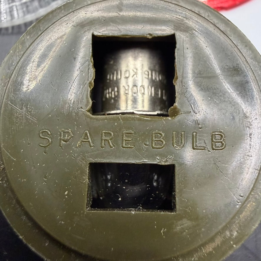 Interior view showing spare bulb compartment in WWII flashlight