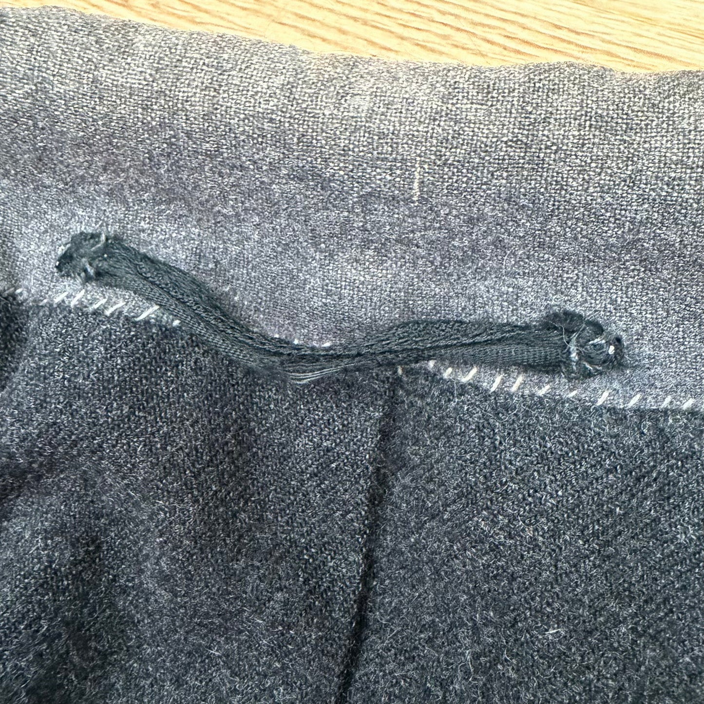 Close-up of heavy wool fabric showing period wear and discoloration