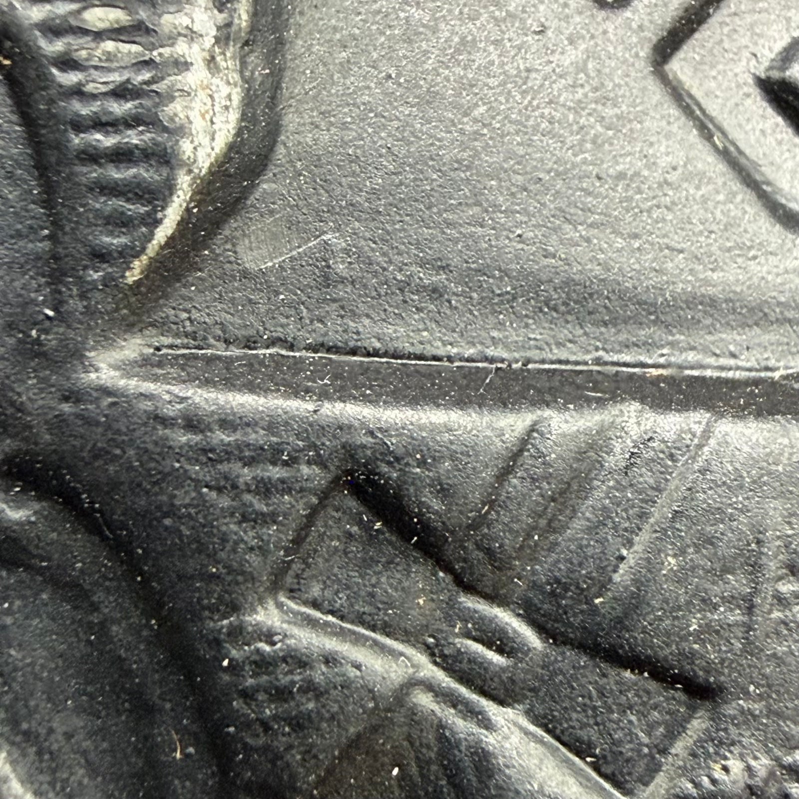 Close-up of faint EH marking lower left in helmet