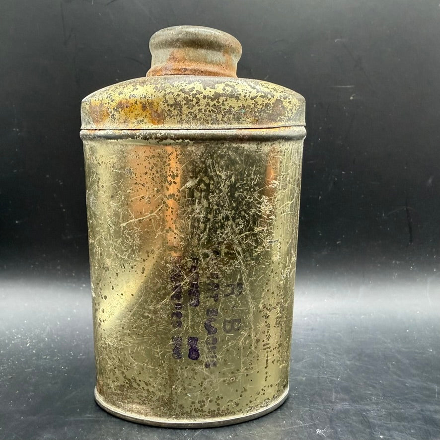 Rear view of original British WWII foot powder container with patina
