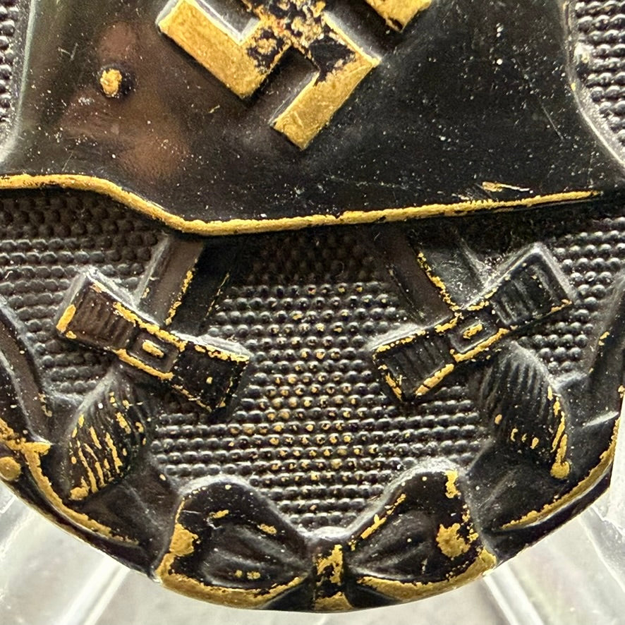 Detail of crossed swords and textured background on WWII German Wound Badge in Black