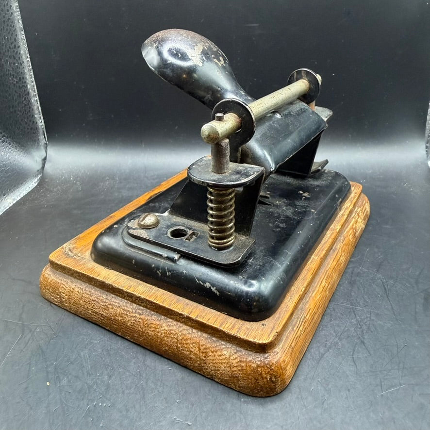 Side view of heavy cast metal German office hole punch Soennecken model 231/B