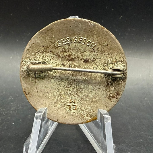 Reverse side DRK badge E.L.M. GES GESCH maker mark