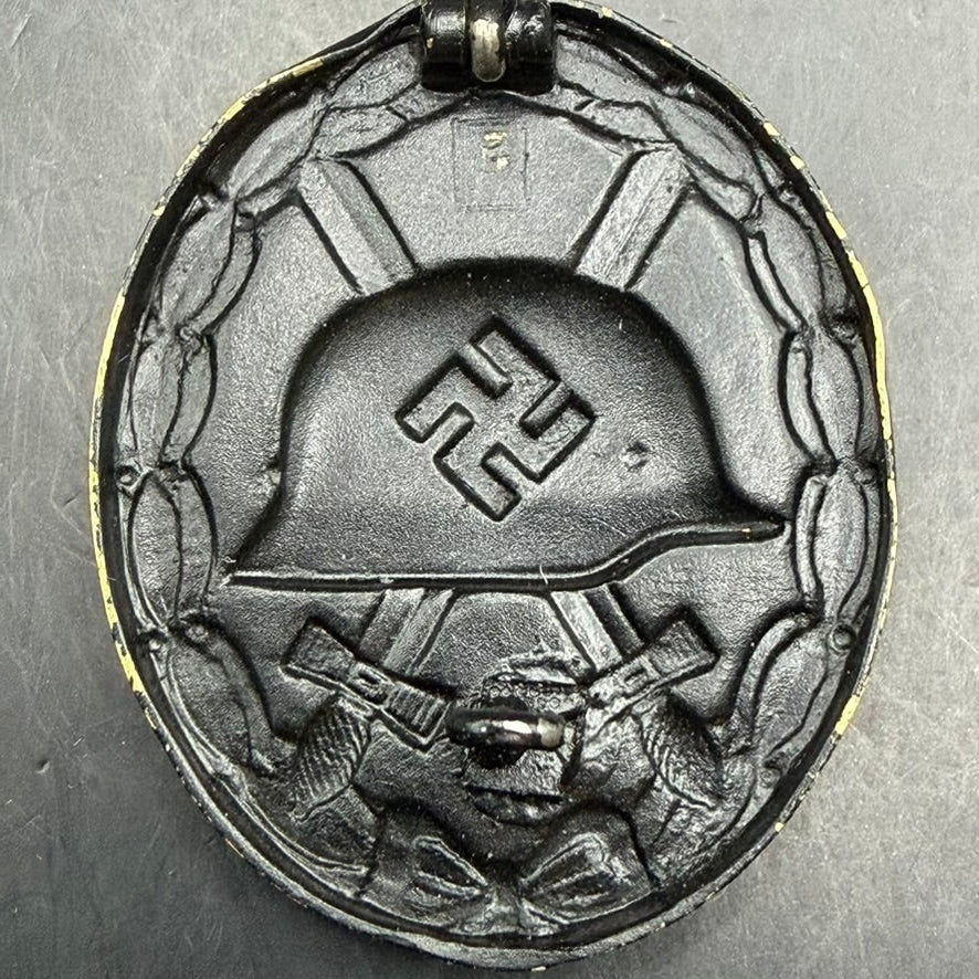 Rear detail of WWII German Wound Badge showing brass body and black finish