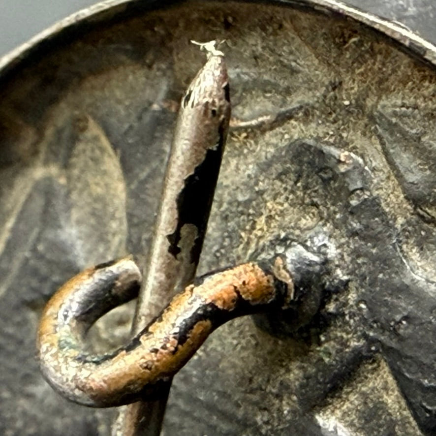 Detail of question mark catch and sharp iron pin on WWII German Wound Badge in Black