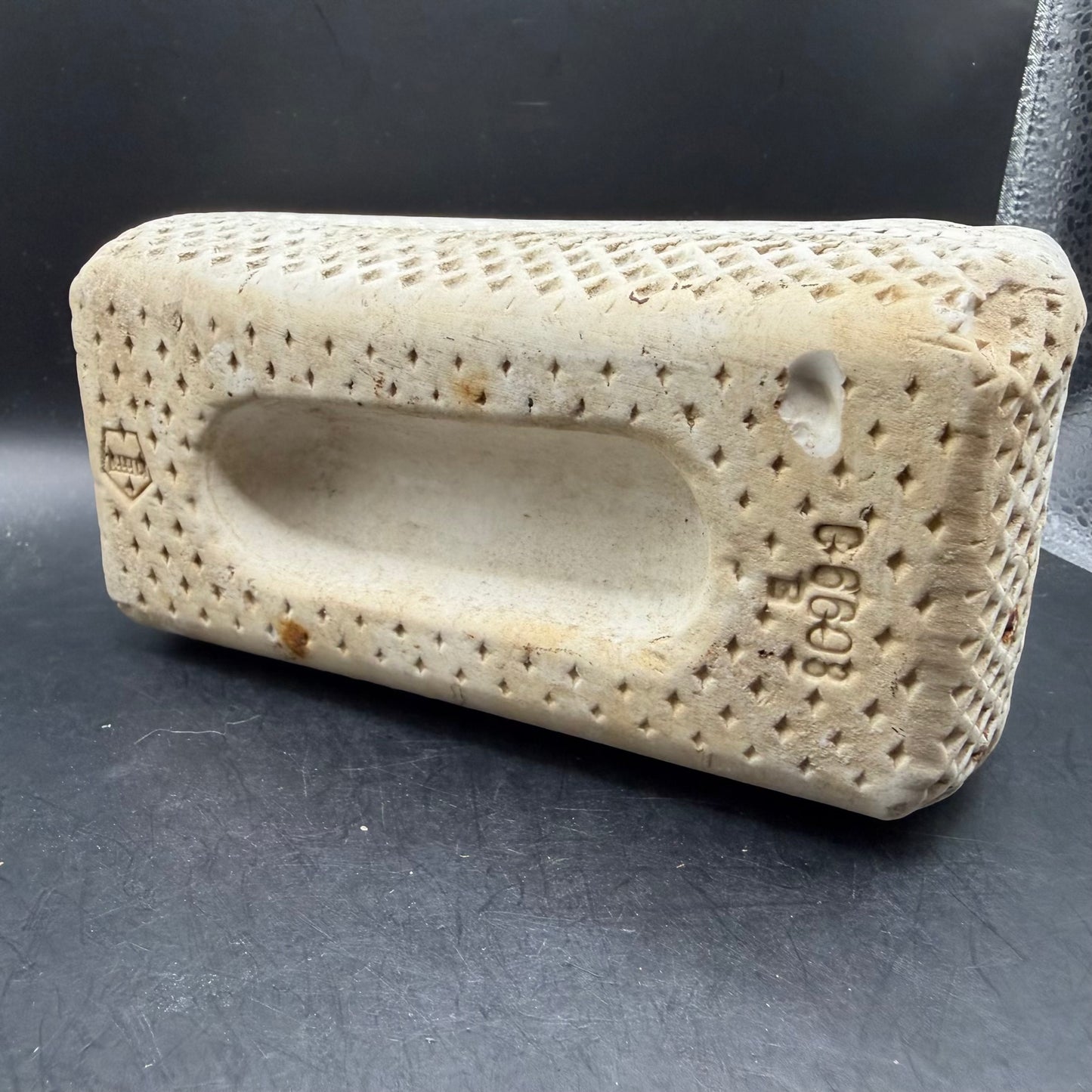 End view of concrete runway marker with textured surface