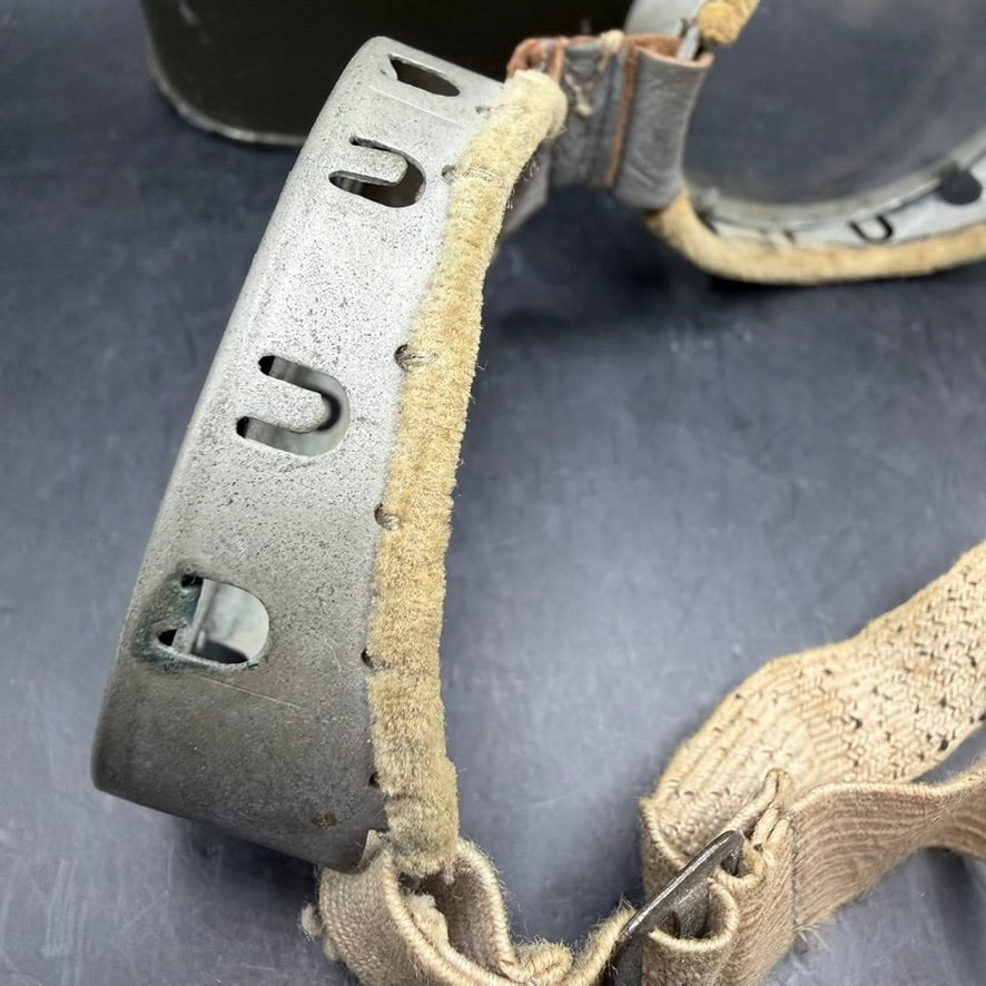 Close-up of metal frame and felt padding on British military goggles