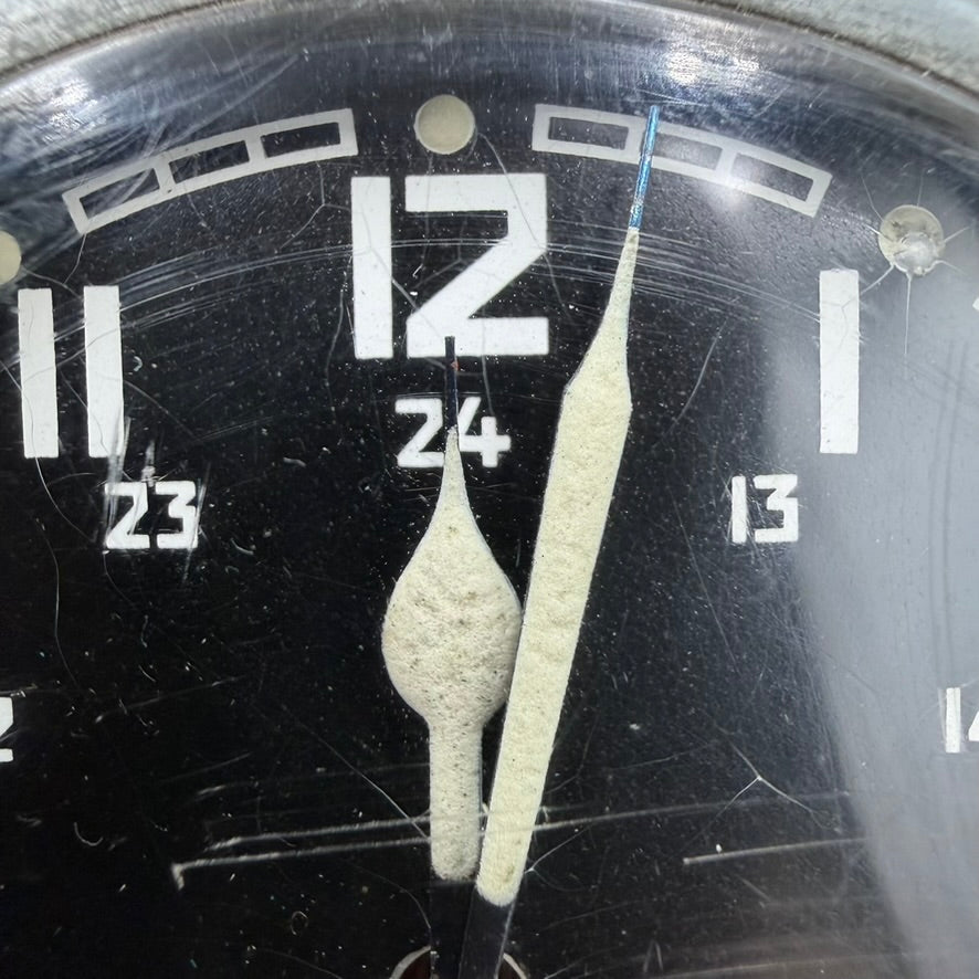 Close-up of luminous hour and minute hands with 24-hour scale