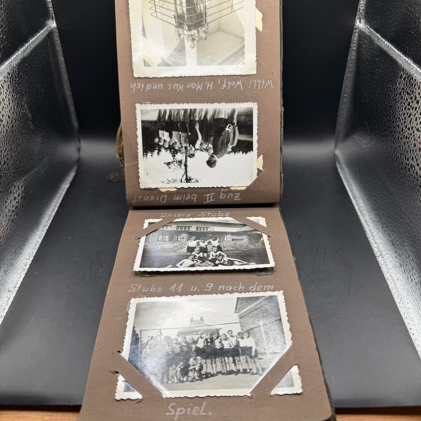 Open WWII German photo album with original photographs and mounting corners