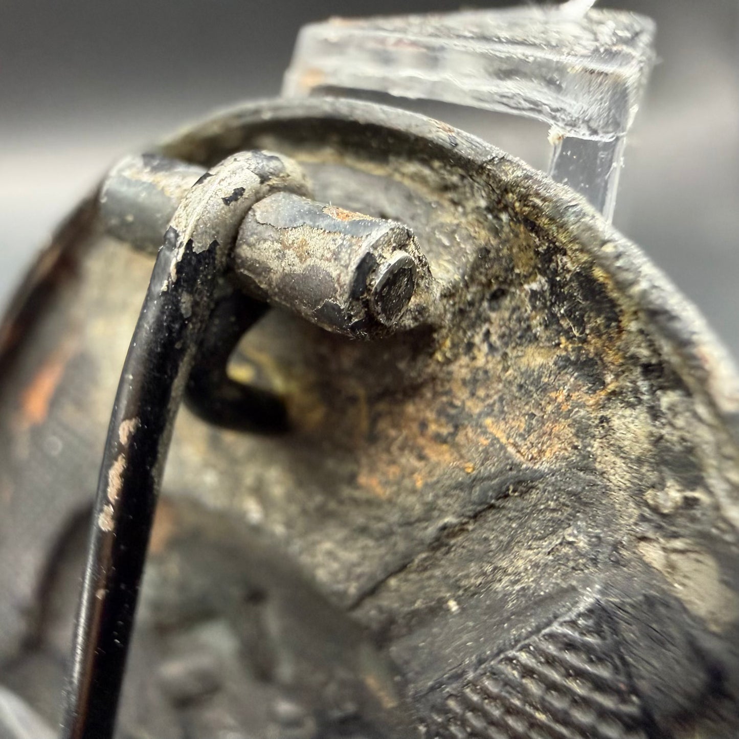 Close-up of worn black finish and exposed iron