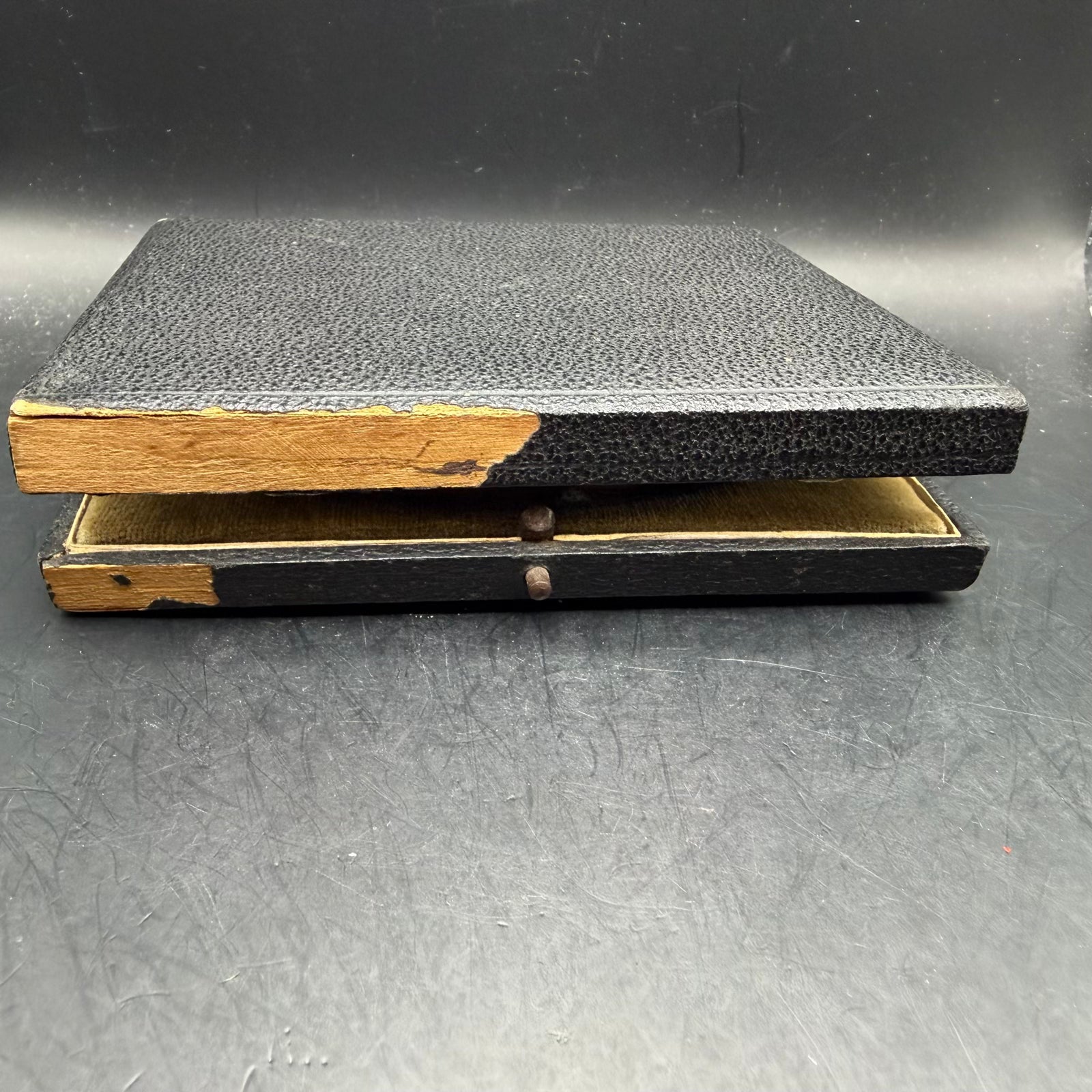 Side view of original NSFK medal case showing period wear