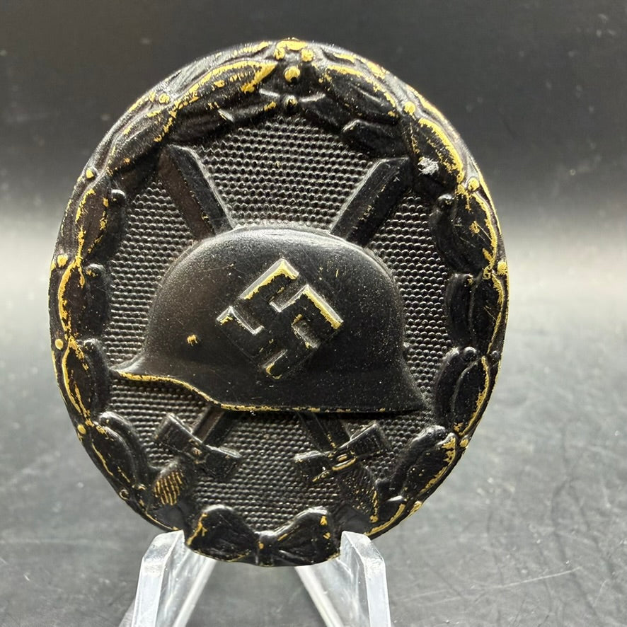 Front view of WWII German Wound Badge in Black showing helmet and laurel wreath