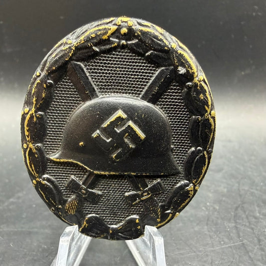 Front view of WWII German Wound Badge in Black showing helmet and laurel wreath
