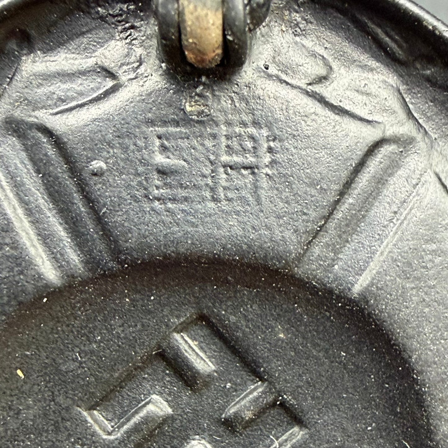 Detail of EH maker initials on reverse