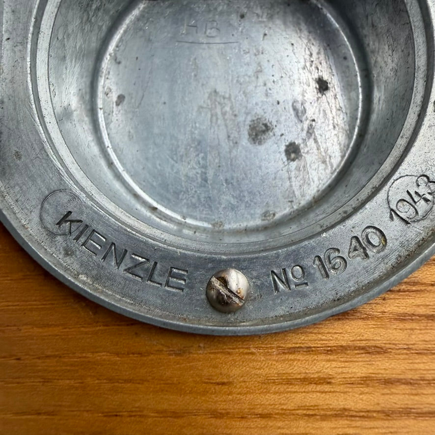Rear housing of Kienzle clock with manufacturer markings and serial number