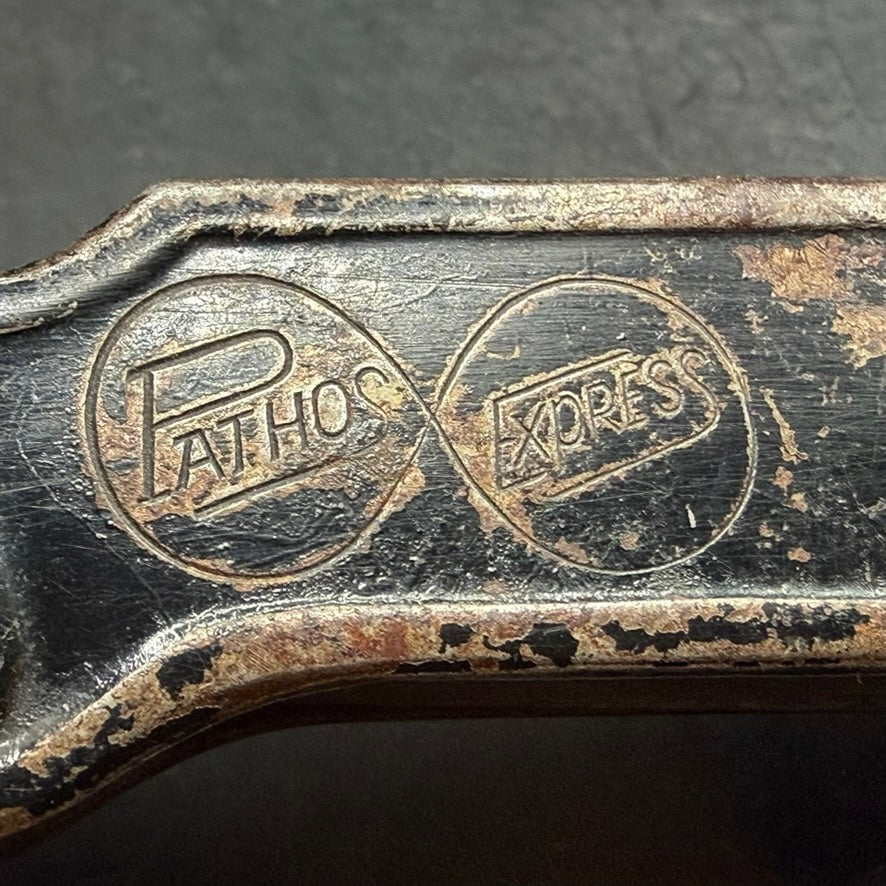 Detail of PATHOS and EXPRESS factory stamps on German can opener