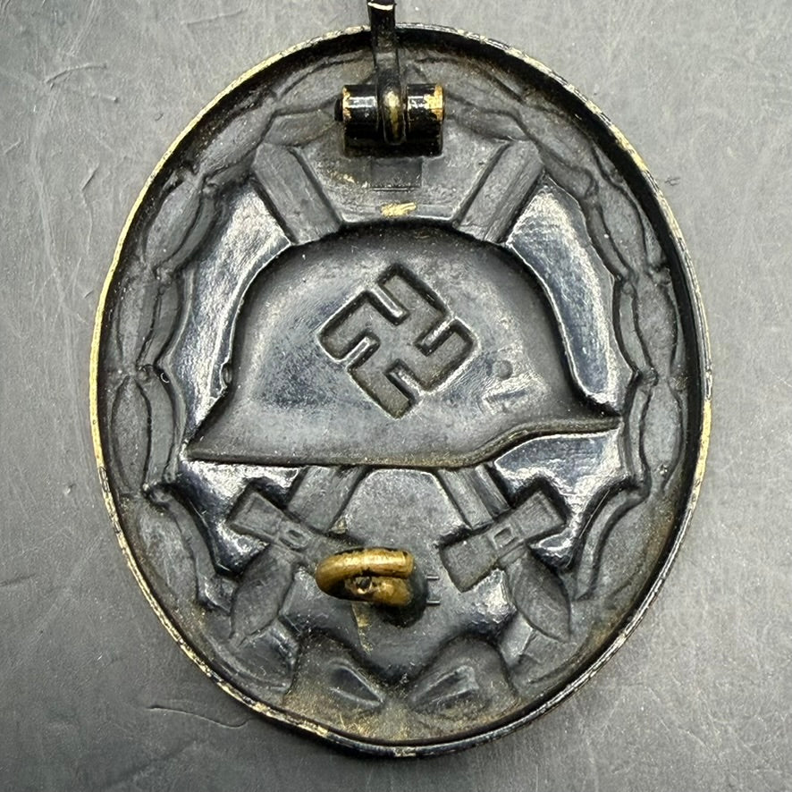 Full reverse view of brass WWII German Wound Badge in Black with original pin assembly