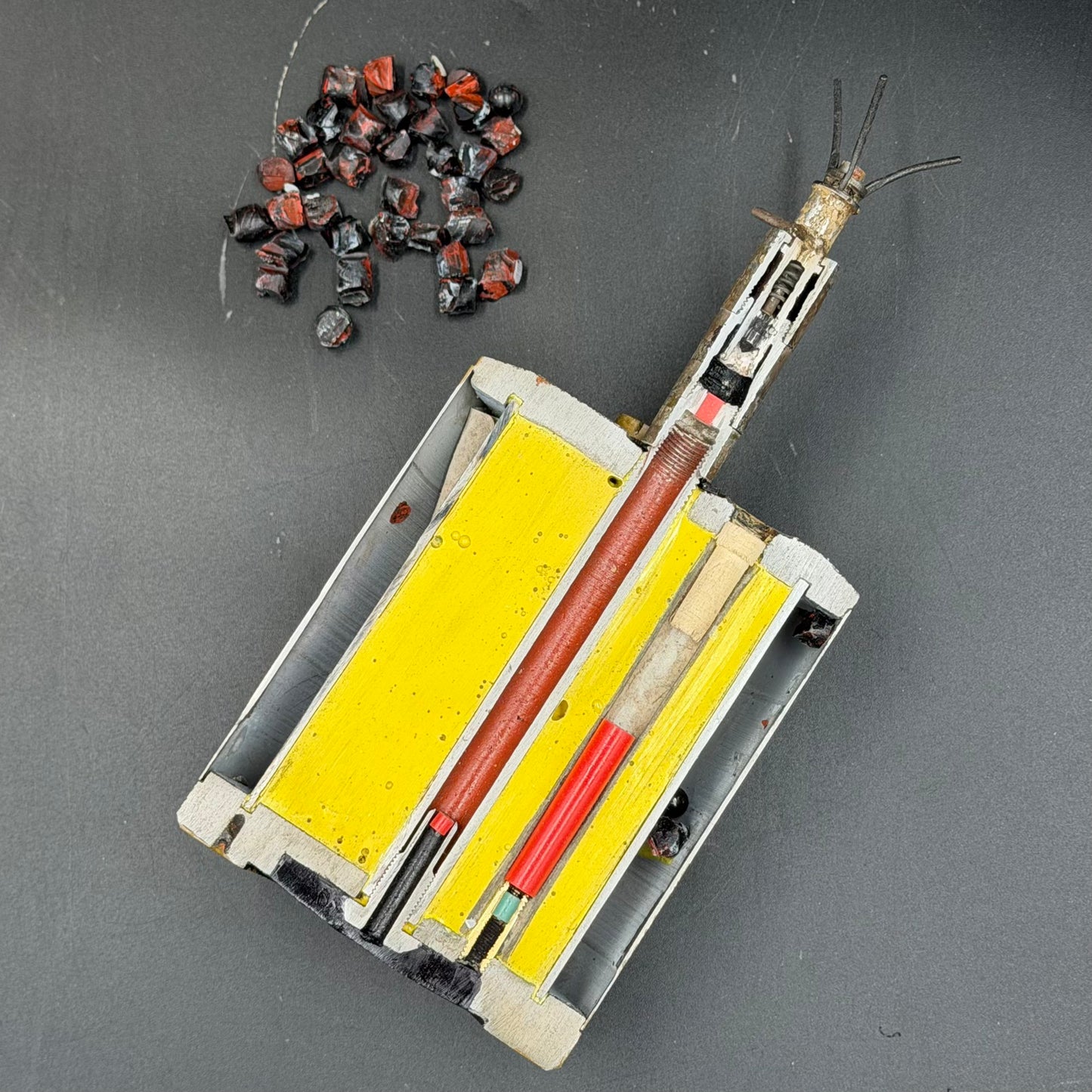 Sectioned WWII German S-mine displayed horizontally showing full internal layout