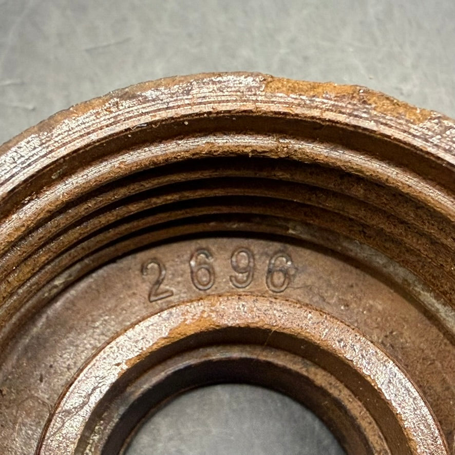 Interior of metal cap showing stamped marking “2696”