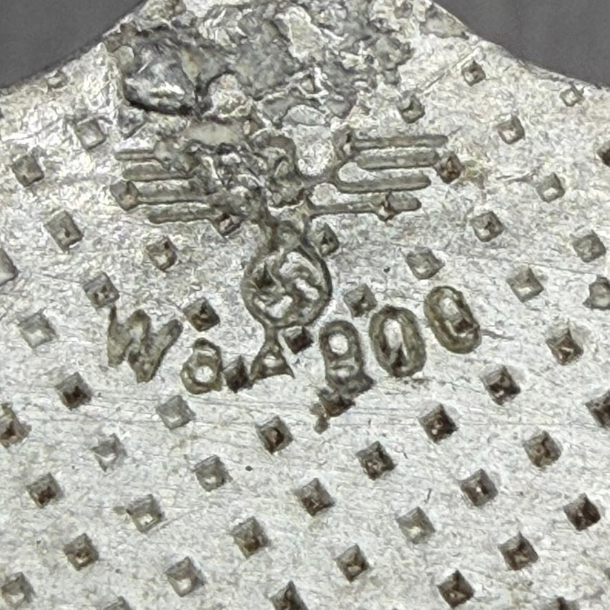 Detail of stamped markings on German Enigma machine rotor Waffenamt