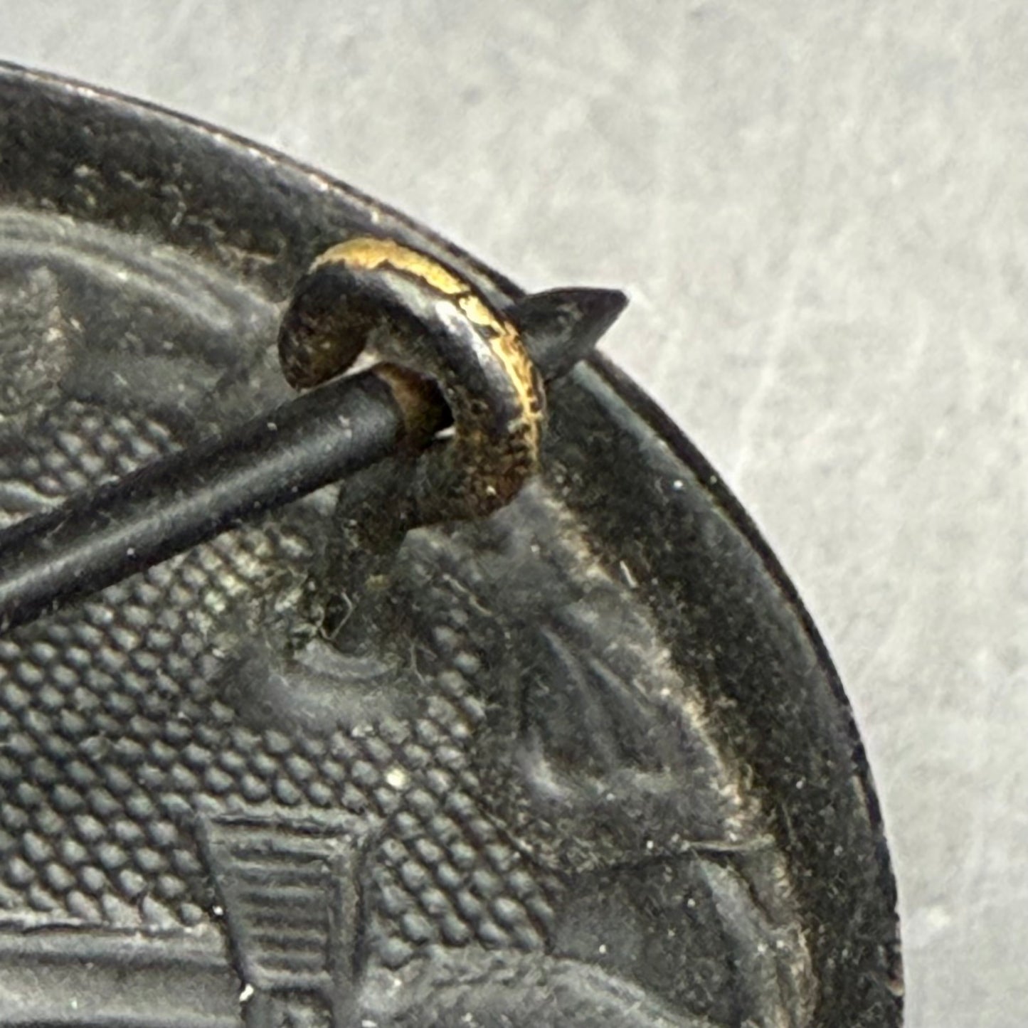 Detail of iron question mark catch on Meyers wound badge