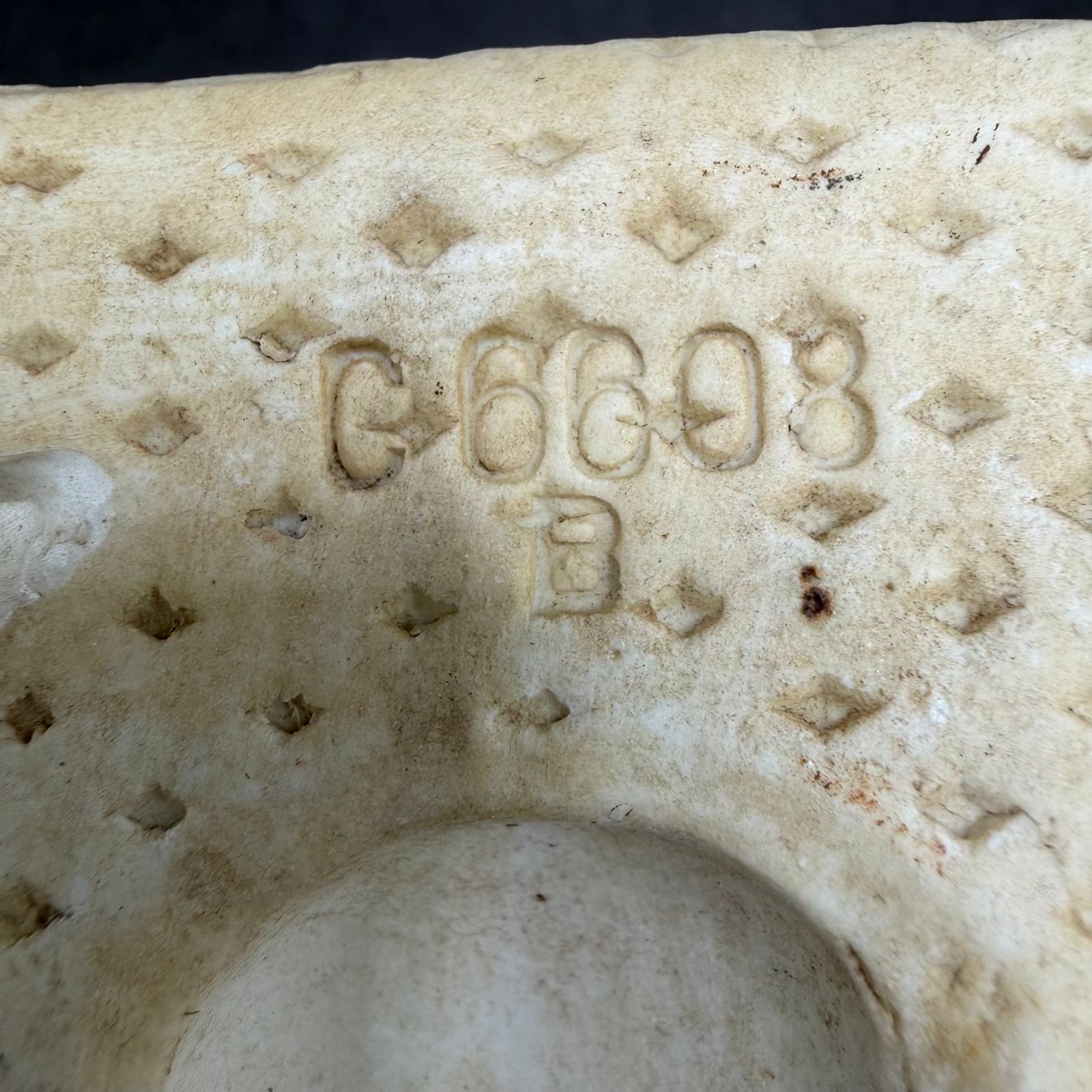 Stamped marking “C 6608 B” on WWII airfield marker