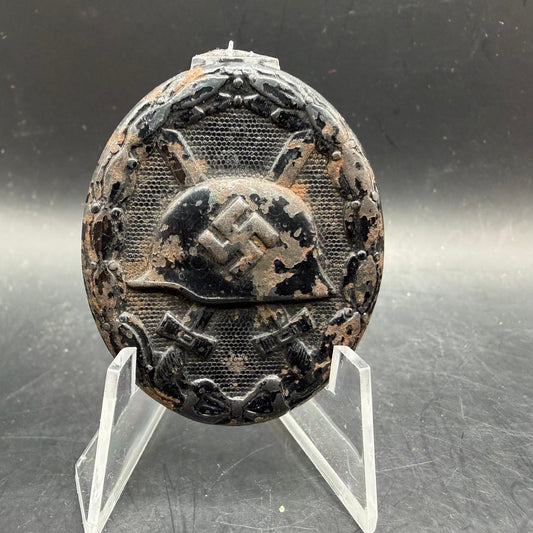 Front view of WWII Black Wound Badge with heavy paint loss